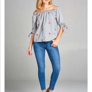 Off the shoulder, floral embroidered top.